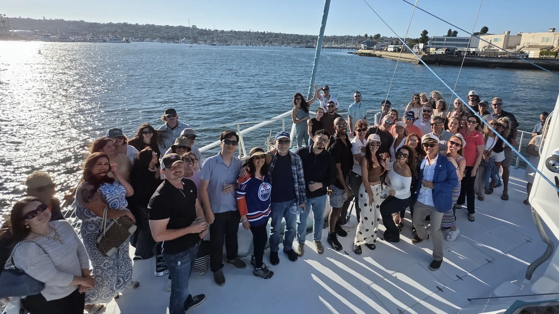 Our tribe gathered together on the deck of a sailboat in the harbor.